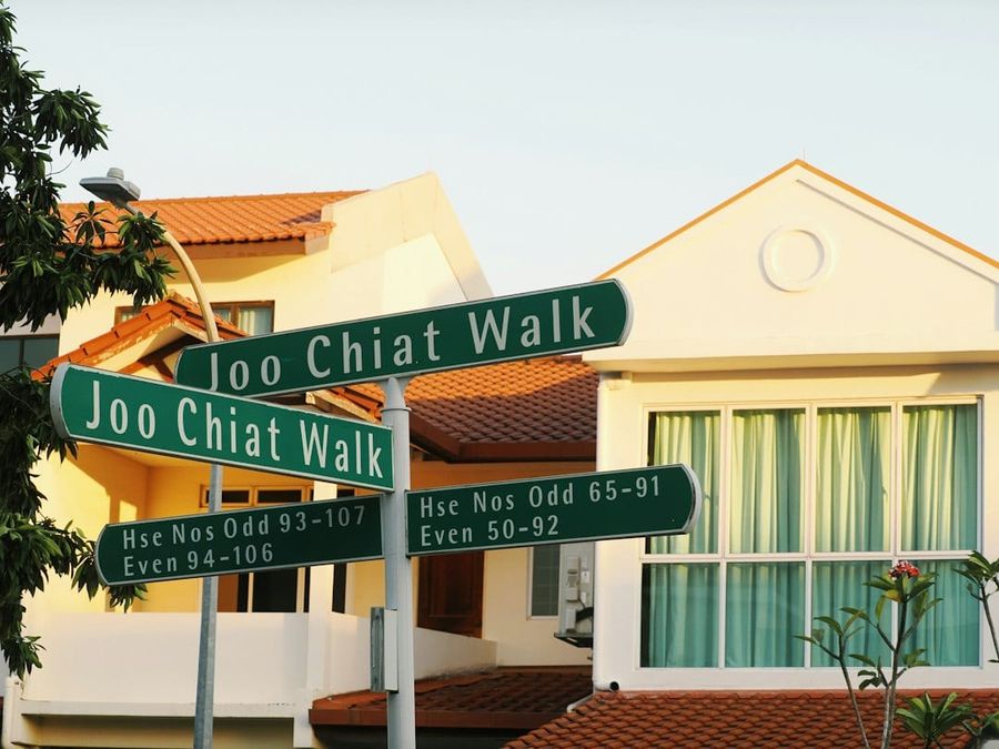 Singapore residential street with landed homes and mature trees